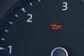 The automobile tachometer has a low oil indicator on it. Close-up