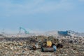 Automobile wagon and bulldozer at the garbage dump full of smoke, litter, plastic bottles,rubbish and trash at tropical island Royalty Free Stock Photo