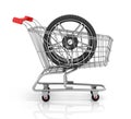 Automobile wheels and shopping cart. Royalty Free Stock Photo