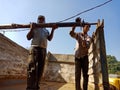 automobile workers installing iron logs into the truck at workshop in india dec 2019