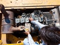 automobile workers repairing hydraulic machine at workshop in india dec 2019 Royalty Free Stock Photo