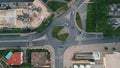 Automobiles riding ring road in small city top view. Round traffic at cozy town