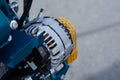 Automotive alternator mounted on a modern engine in a bright workshop setting. Concept for power generating device for industry, Royalty Free Stock Photo