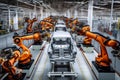 Automotive assembly line with robotic arms and workers assembling vehicles in a modern factory Royalty Free Stock Photo
