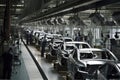 automotive assembly line, with workers building cars and trucks in blur of motion
