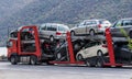 An automotive car carrier truck driving down the highway with a full load of new vehicles. Royalty Free Stock Photo