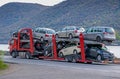 An automotive car carrier truck driving down the highway with a full load of new vehicles. Royalty Free Stock Photo