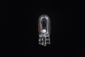Automotive classic halogen bulb. Filament, glass and metal, high energy consumption. Black background. Close-up view. copy space.