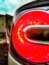 Automotive detail headlight in an enlarged scale