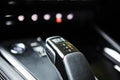 Automotive detail in a luxury car. Modern Luxury car inside. Interior of prestige modern car. Automatic gear stick shift