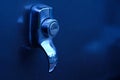 Close up of silver car keyhole with blue light Royalty Free Stock Photo