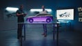 Automotive engineers examine the prototype car model in different shade of light