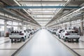 automotive factory, with rows of cars in various stages of assembly