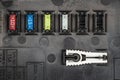 Automotive fuses on a black panel with holders and multi-colored markings - a protective device that opens the electrical circuit