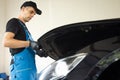 Automotive mechanic man open a car hood and check up the engine. Vehicle service manager worker work in mechanics garage