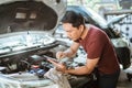 Automotive mechanic repairmen use tablets and check the system working engine