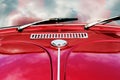 Automotive Nostalgia: Retro Red Car with Reflected Clouds