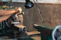 Professional machinist : man operating lathe grinding machine - metalworking industry concept. Mechanical Engineering control lath Royalty Free Stock Photo