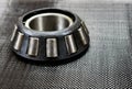 Automotive tapered roller bearing on carbon fiber. Royalty Free Stock Photo