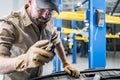 Automotive Technician Worker Repairing Broken Vehicle