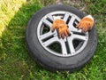 Automotive wheel removed for replacement lies on the ground