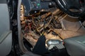 Automotive wiring under the wheel of an old German car, a disassembled dashboard for repairing and connecting electrical