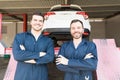 Automotive Workers Showing Contentment In Garage Royalty Free Stock Photo