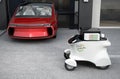 Autonomous delivery robot in front of the garage waiting for picking pizza