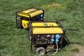Autonomous portable yellow diesel generator stands on the grass Royalty Free Stock Photo