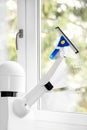 A autonomous robot is washing a window