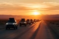 autonomous vehicle convoy, traveling on desert road at sunset