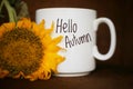 Autum coffee concept with yellow sunflower closeup. White mug of coffee with text - Hello Autumn Royalty Free Stock Photo