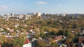 Autumn aerial view of cityscape with cloudy blue sky from the drone.