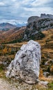 Autumn alpine Dolomites mountain scene. Peaceful Valparola Pass view, Belluno, Italy. Snowy Marmolada massif and Glacier in far Royalty Free Stock Photo