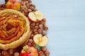 Autumn apple pie decorated with various ingredients - fresh sliced apples, hazelnuts, spices - anise, cinnamon. Thanksgiving tart Royalty Free Stock Photo