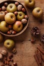 Autumn apples with nuts and cinnamon sticks on table Royalty Free Stock Photo