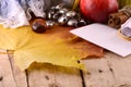 Autumn. Apples, plums, grapes and yellow leaves on wooden plate