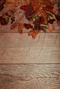 Autumn arrangement of colorful leaves, acorn, chestnut fruit on a wooden background with free space for text. Top view Royalty Free Stock Photo