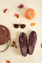 Autumn Arrives sales. Fall Fashion casual Lady Look. Trendy round Handbag, Stylish Sunglasses and brown leather shoes on yellow Royalty Free Stock Photo