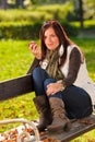 Autumn attractive woman eat apple sunset park Royalty Free Stock Photo