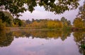 colorful autumn around the pond, autumn pond, reflections on the pond surface Royalty Free Stock Photo