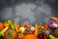 Autumn background: autumn vegetables, fruits, nuts on a beton background