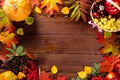 Autumn background with basket, yellow maple leaves, grapes, red apples. Frame of fall harvest on aged wood with copy space Royalty Free Stock Photo