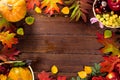 Autumn background with basket, yellow maple leaves, grapes, red apples. Frame of fall harvest on aged wood with copy space Royalty Free Stock Photo