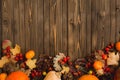 Autumn background with colored leaves and pumpkins on wooden board Royalty Free Stock Photo