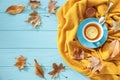 Autumn background concept - blue cup of black tea with lemon slice and honey on a yellow scarf, dried leaves on a blue wooden back Royalty Free Stock Photo