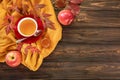 Autumn background concept - red cup of tea with piece of lemon, red freshly fallen leaves, red apples, honey on a wooden backgroun Royalty Free Stock Photo