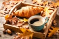 Autumn background with cup of black coffee, croissant and fall oak leaves Royalty Free Stock Photo