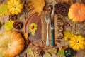 Autumn background with fall leaves and pumpkin over wooden table. Royalty Free Stock Photo