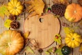 Autumn background with fall leaves and pumpkin over wooden table. Royalty Free Stock Photo